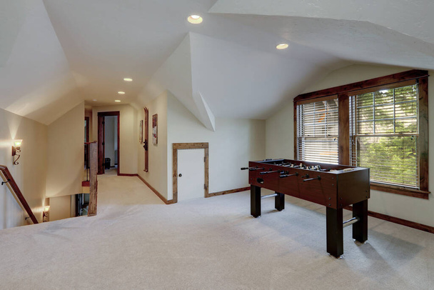 Hockey play table in upstairs family play room with vaulted ceiling. - Photo, Image