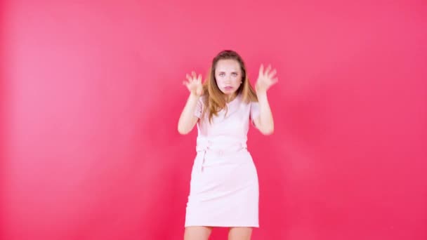 Cheerful woman dancing over red background - Metraje, vídeo