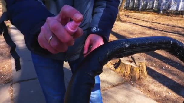 A man treats his hands with an antiseptic and spreads the handle of a pram. Quarantine. Kiev. Ukraine. Coronavirus - Footage, Video