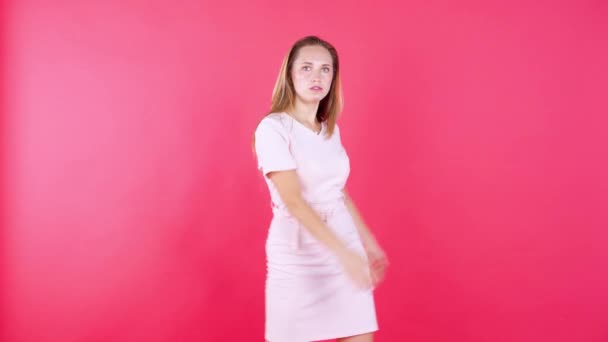 Cheerful woman dancing over red background - Metraje, vídeo