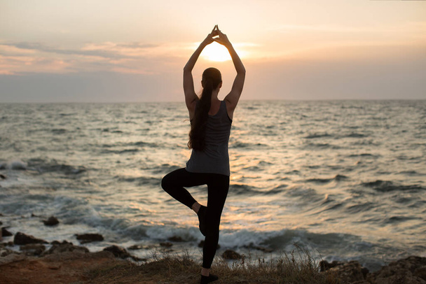 Donna caucasica che pratica yoga in riva al mare dell'oceano
. - Foto, immagini