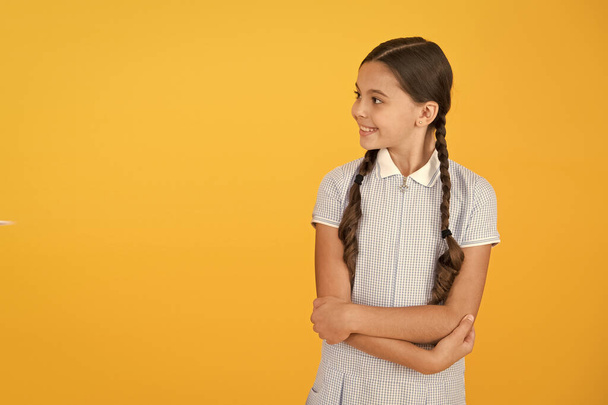 back to school. happy beauty on yellow background. happy childhood. hair health concept. girl with long hair. smart girl in vintage dress. little girl retro uniform. old school fashion. copy space - Foto, Imagen