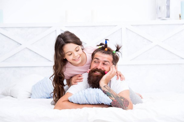 Funny hairstyle. Compressed into boundaries of home. Happy childhood. Family leisure. Pajamas party. Hairdresser or stylist. Relaxing in bedroom. Girl and dad. Quarantine with children. Happy family - Photo, image