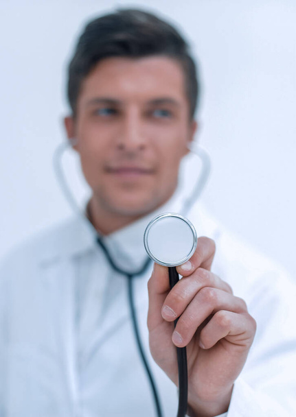smiling doctor showing stethoscope - Valokuva, kuva