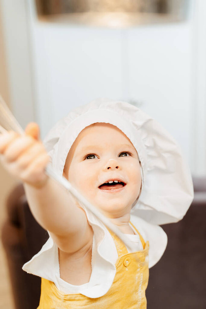 Adorable little girl in a cook hat - Photo, image