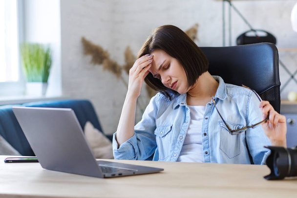 Tired freelancer working overtime in home office.Stressed businesswoman have financial problems and searching ideas to overcome financial crisis.Entrepreneur in bankruptcy,Burnout and overwork concept - Photo, Image