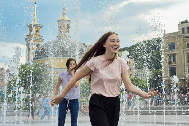 Teenage girls, people having fun in the city fountain - Zdjęcie, obraz