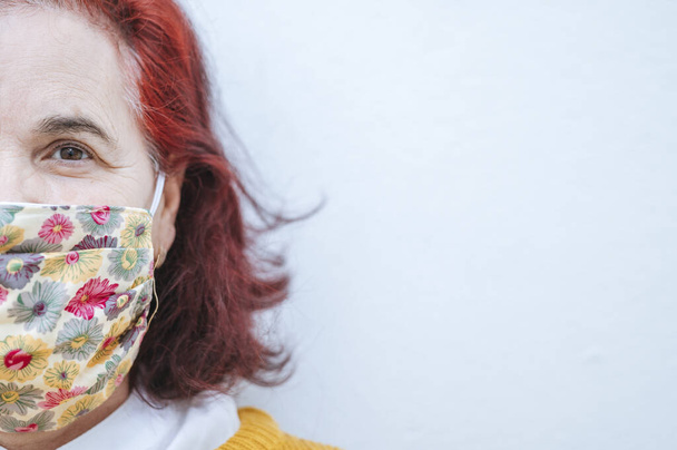 Portrait of mature woman with protective mask - Photo, image