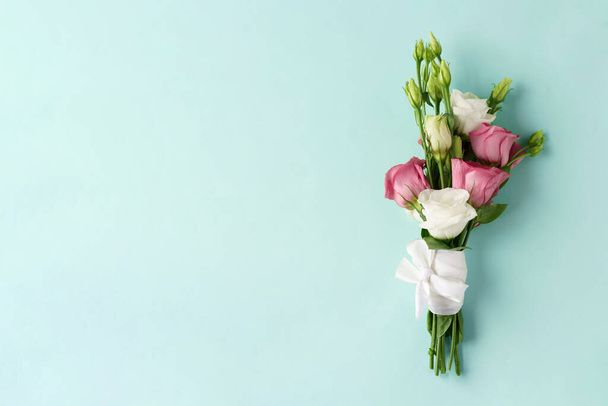 Bouquet of Flowers eustoma pink and white on blue background - Photo, Image