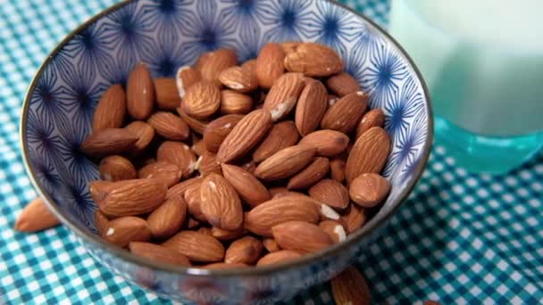  close up of almond nut in a bowl and milk on table  - Footage, Video