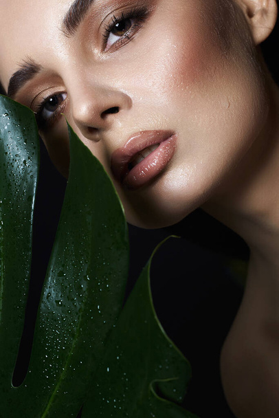 beautiful wet girl in palms. Beautiful woman with Make-up. Beauty Portrait. wild woman in Jungle. - Photo, Image