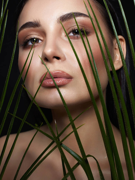 beautiful girl in palms. Beautiful woman with Make-up. Beauty Portrait. wild woman in Jungle. - Photo, Image