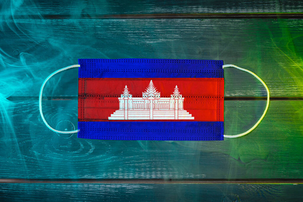 Medical mask for protection against airborne diseases, painted in the national flag of Cambodi - Photo, Image