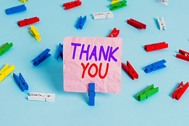 Handwriting text Thank You. Concept meaning a polite expression used when acknowledging a gift or service Colored clothespin papers empty reminder blue floor background office pin. - Photo, Image