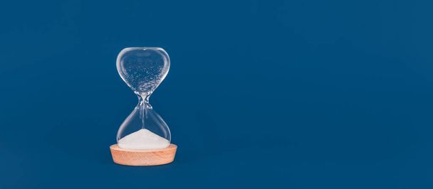 Hourglass with the last drops of sand. Concept of time and timely actions, closing opportunities - Photo, Image