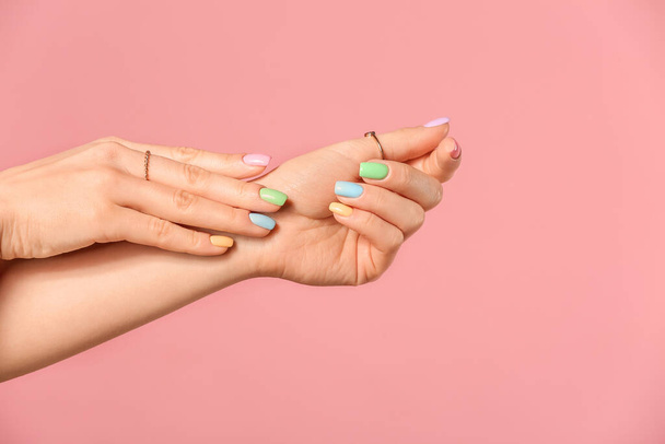 Hands of young woman with beautiful manicure on color background - 写真・画像