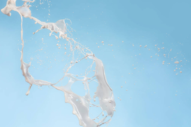 Splash of milk on color background - Photo, Image