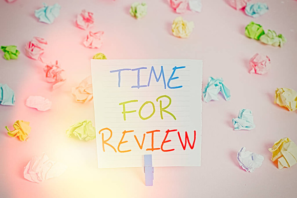 Conceptual hand writing showing Time For Review. Business photo showcasing review of a system or situation in its formal examination Colored crumpled papers empty reminder pink floor clothespin. - Photo, Image