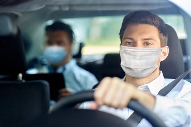 taxi driver in face protective mask driving car - Foto, Imagem