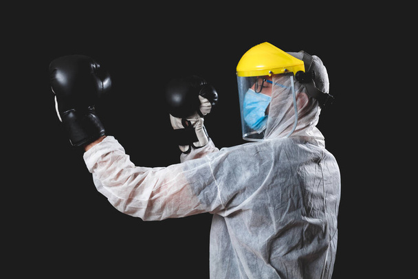Doctor / surgeon / scientist with boxing gloves ready to fight the virus and illness. - Foto, imagen