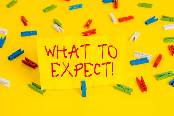 Handwriting text writing What To Expect. Concept meaning asking about regard something as likely to happen occur Colored clothespin papers empty reminder yellow floor background office. - Photo, Image
