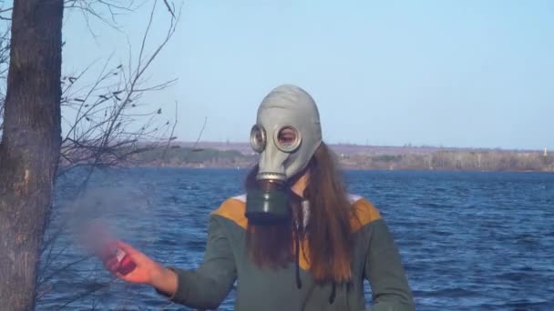 Girl in a gas mask with a smoke bomb - Footage, Video
