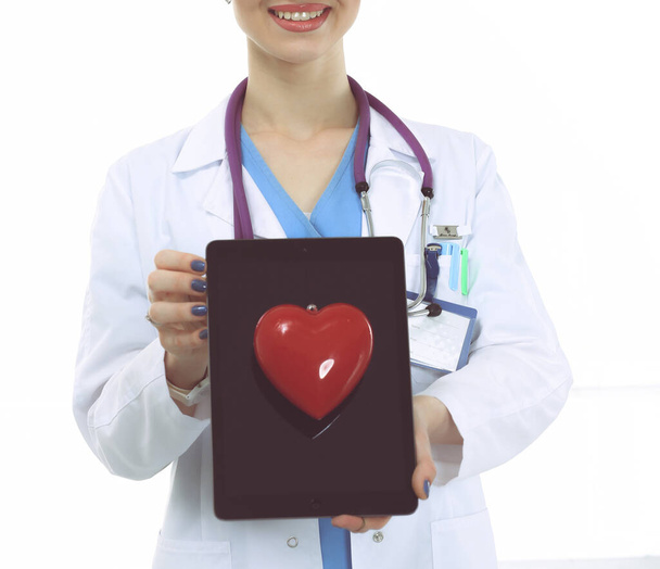 Young woman doctor holding a red heart, isolated on white background. Woman doctor - Фото, зображення