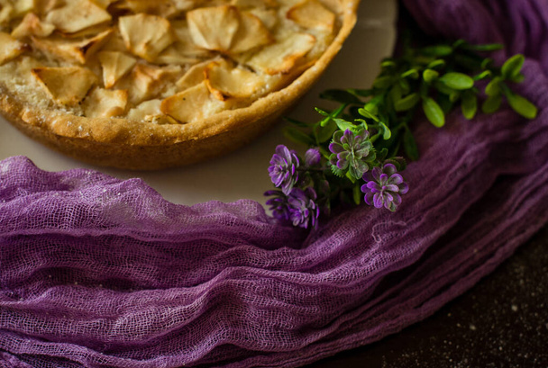 Apple feather on a purple background. Homemade pastries. - Photo, Image