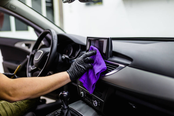 close up of man cleaning car interior, car detailing concept. Selective focus.  - Photo, image