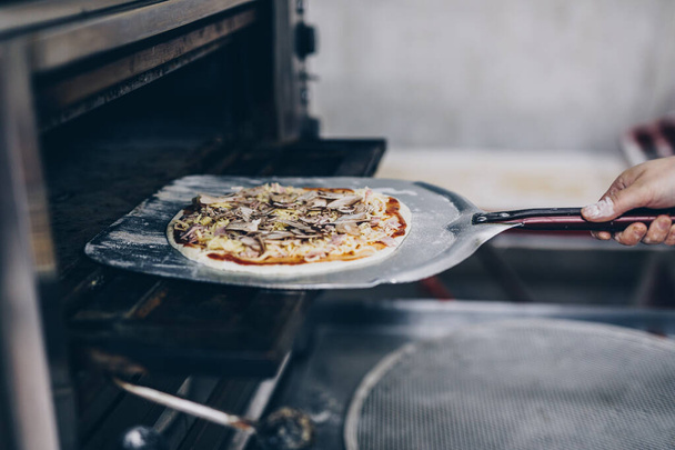Close up shot of pizza making or preparing process  - Foto, Bild