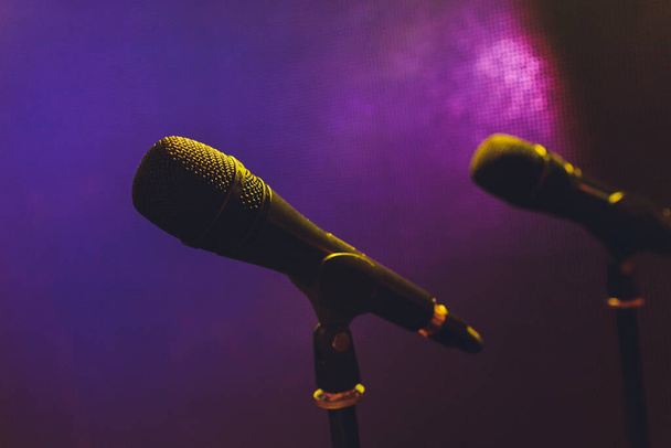 Close up of microphone on stage in audience room blur background. - Foto, imagen