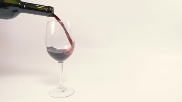 Red wine. Red wine is poured into a glass. - Materiał filmowy, wideo