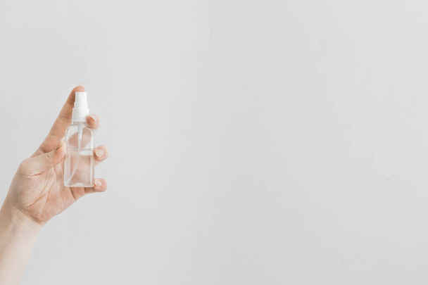 Cropped view of man holding hand sanitizer in spray bottle  - Fotoğraf, Görsel