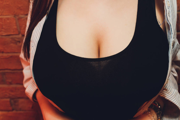 neckline, beautiful large female breast, dress, close-up. - Zdjęcie, obraz