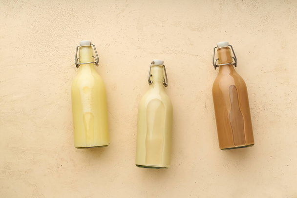Rice with oat and chocolate almond milk in glass bottles on beige background. Healthy protein vegan drinks concept  - Foto, Imagem