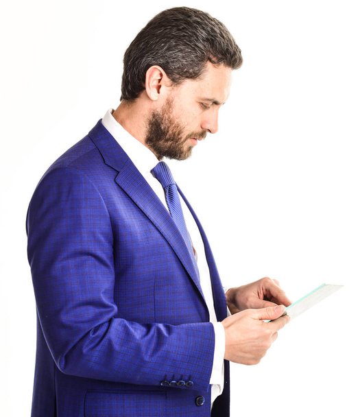 Man with beard in formal wear holds pad or tablet - Fotoğraf, Görsel