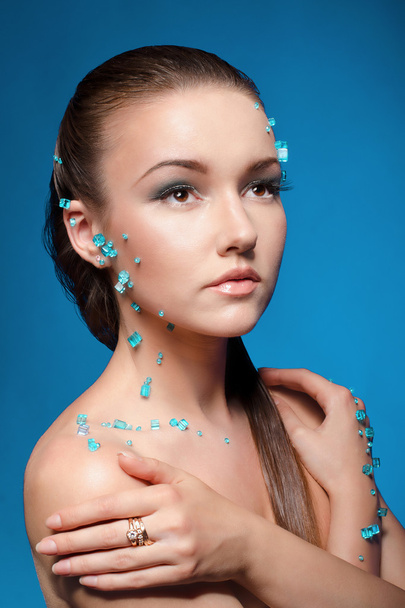 Beautiful naked young woman covered with blue crystals - Photo, Image