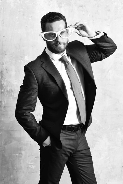 Businessman in stylish blue suit posing with retro white glasses - Фото, изображение