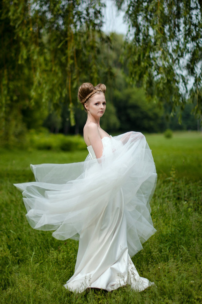 Beautiful blond bride in fashionable wedding dress - Фото, зображення