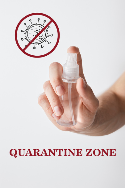 cropped view of man holding hand sanitizer in spray bottle isolated on white, quarantine zone illustration - Фото, изображение