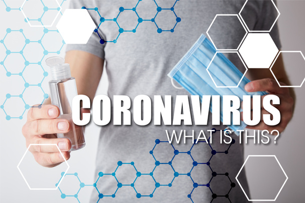 cropped view of man holding gel hand sanitizer in bottle and medical mask on grey background, coronavirus illustration - Foto, immagini