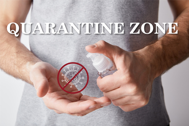 cropped view of adult man using hand sanitizer in dispenser bottle, quarantine zone illustration - Foto, imagen