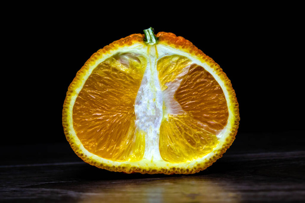 Half of the tangerine on a wooden background - Foto, immagini