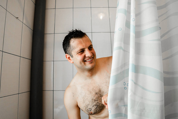man in the shower,young man taking shower,fit caucasian man showering under running water, take care of body. hygiene concept - Valokuva, kuva