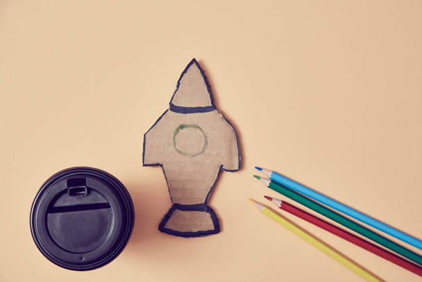 Start-up project. New life, solution. Start new business. Paper rocket launch. Change for better. Coffee cup, pencils - Фото, зображення