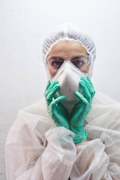 Retrato de una mujer joven con equipo de protección completo, máscara respiratoria y gafas durante el brote de virus
 - Foto, imagen