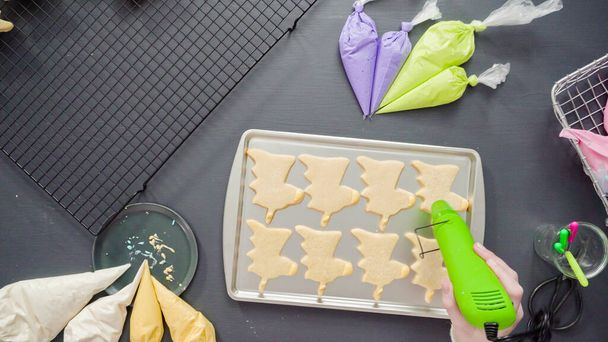 Flat lay. Decorating unicorn sugar cookies with multi-color royal icing. - Photo, Image