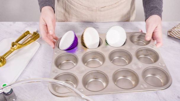 Step by step. Lining cupcake pan with foil cupcake cups. - Photo, Image