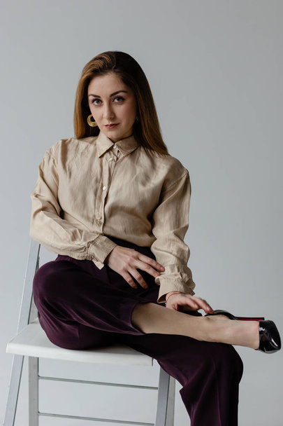 Caucasian young woman wearing blouse on white background - Foto, immagini