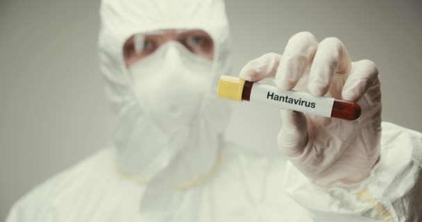 Scientist laboratory protection glasses test tube concept Hanta virus blood gray background showing - Πλάνα, βίντεο